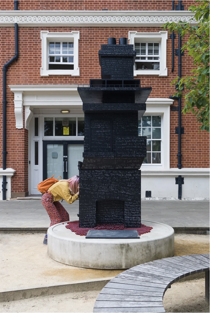 the sculpture in the grounds of goldsmiths and the same pink haired student is peeping through the holes