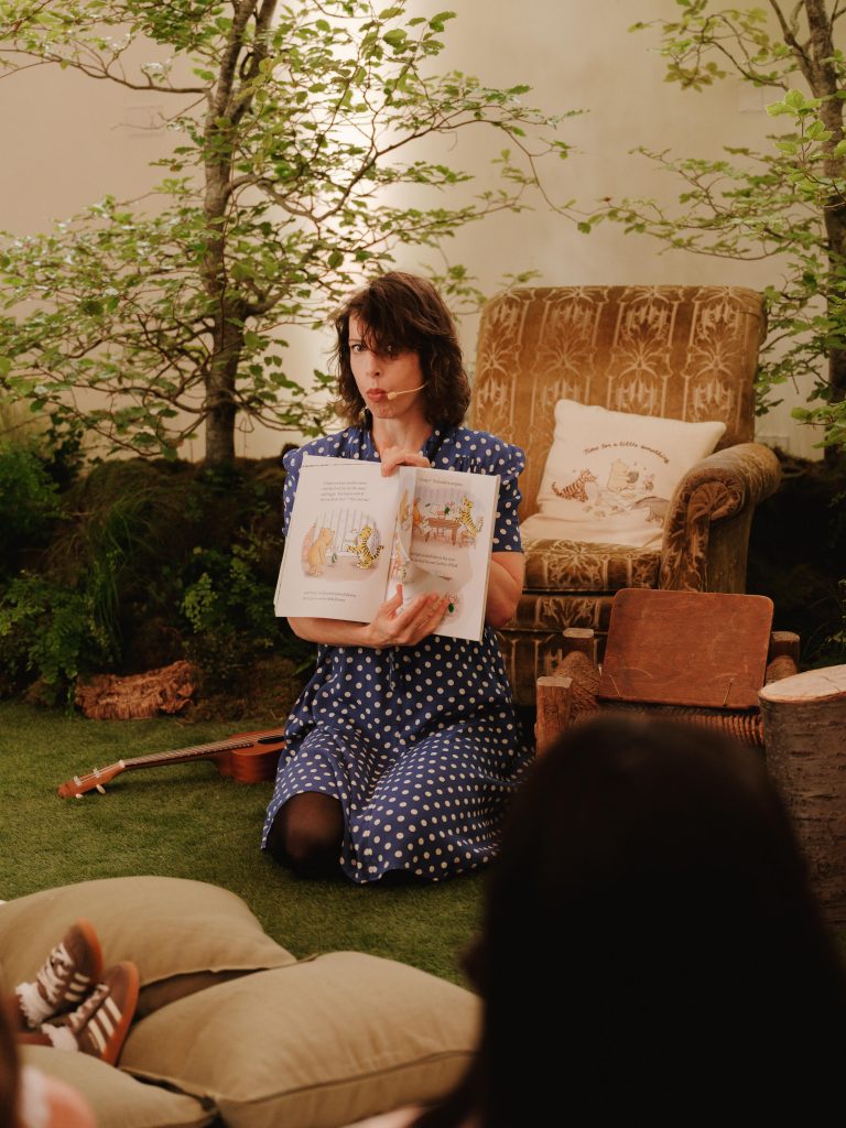vanessa reading a whinnie the pooh book in a cute vintage style indoors woodland setting.